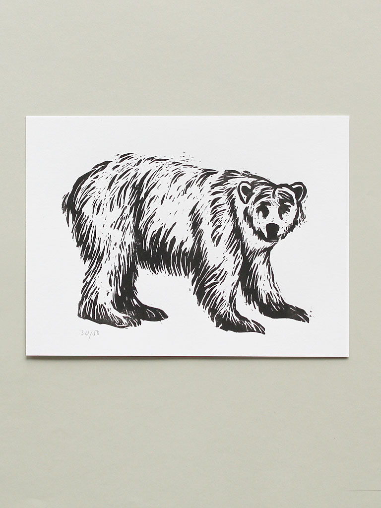 woodblock print of a polar bear in black and white