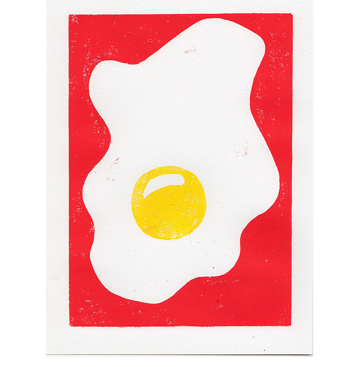 hand-pulled woodblock print of a fried egg sunny side up on red background